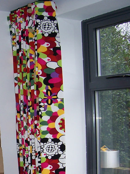 30mm black Metropole with colourful Missoni fabric, dressed like a sine curve under the pole, this minimises the bulk of the curtain without looking skimp