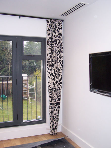 30mm black Metropole with black and white Missoni fabric, dressed like a sine curve under the pole, this minimises the bulk of the curtain without looking skimpy