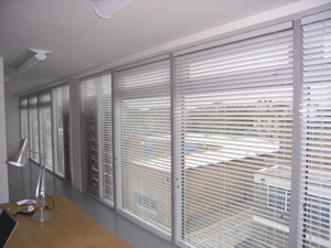 50mm aluminium venetian blinds covering an entire wall of this modern studio / workshop in Hackney