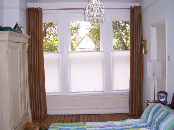 Artificial silk curtains, eyeletted on a pole with bottom up blinds for privacy 