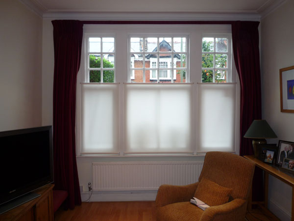 Bottom Up roller blinds fitted in Friern Barnet. Using a cup hook system these blinds will be left half way up most of the time, although they can be lowered when required. 