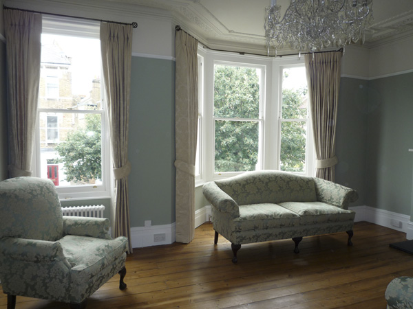 Traditional Sanderson damask interlined and pinch pleated on bay window and straight pole