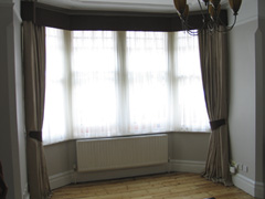 Simple contrast pelmet connects the two curtains and conceals a pair of tracks Finchley