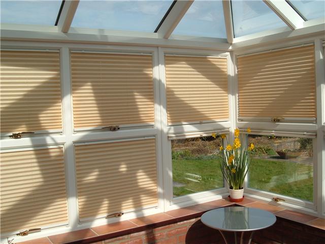 Separate pleated blinds for each window so that the windows will still function unimpaired but shaded 