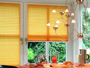 Yellow pleated blinds fitted to opening windows, attached top and bottom so that the windows operate normally 
