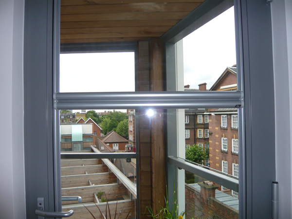 Luxaflex Nano blind fitted to a door in London, blind fully retracted into barrels, barrels in middle of door