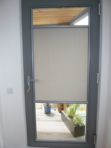 Luxaflex Nano blind fitted to a door in London, covering the middle again