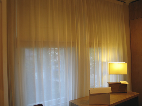 Blackout Roman Blinds fitted behind voile curtains