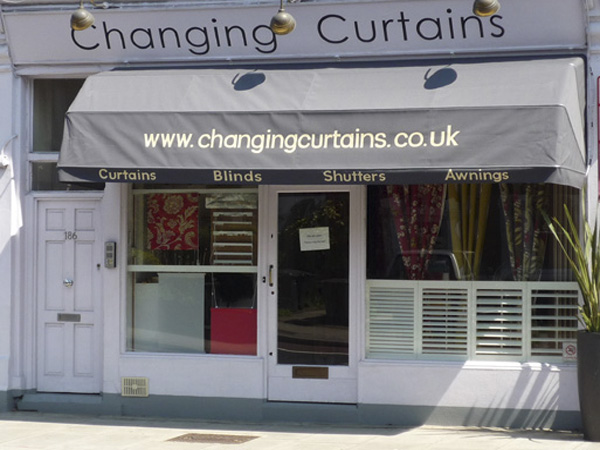 shopfront photo of changing curtains with display of blinds shutters and curtain fabric