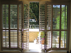 89mm louvres in lime white hanging from tracking system on patio doors Hackney