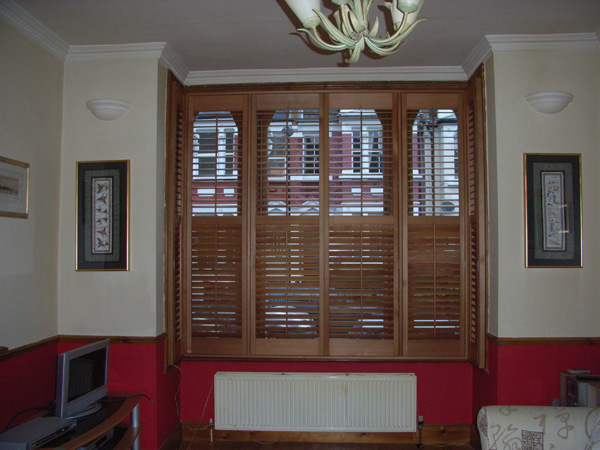 Attractive and efficient. Oiled Western Red Cedar shutters with 63mm louvres positioned above the convection radiator. 