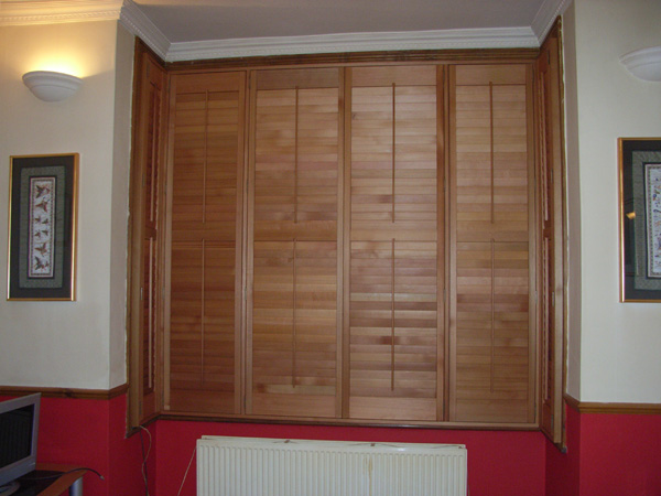 Attractive and efficient. Oiled Western Red Cedar shutters with 63mm louvres positioned above the convection radiator. 