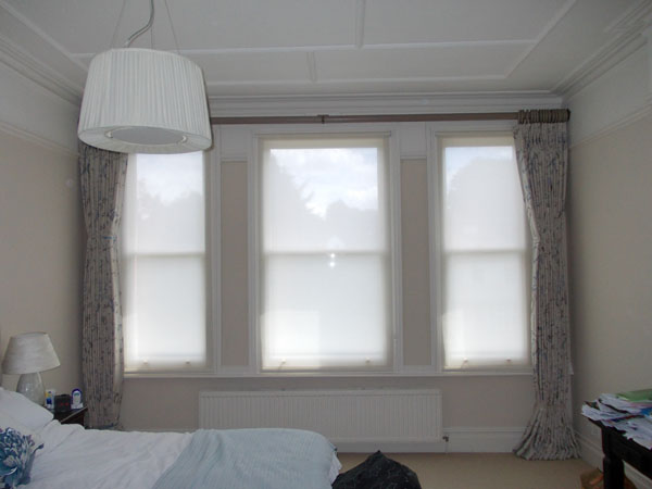 Wall to wall wooden pole and curtains, with voile privacy blinds