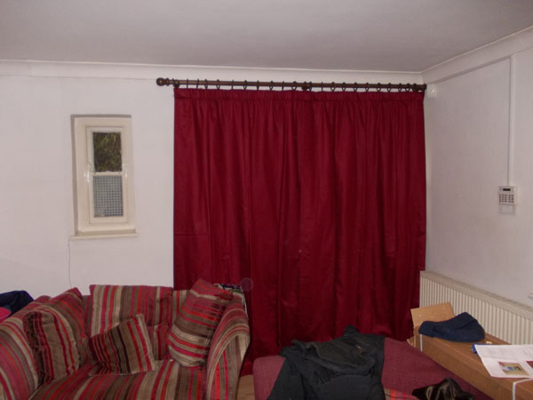 interlined curtains hanging on wooden pole