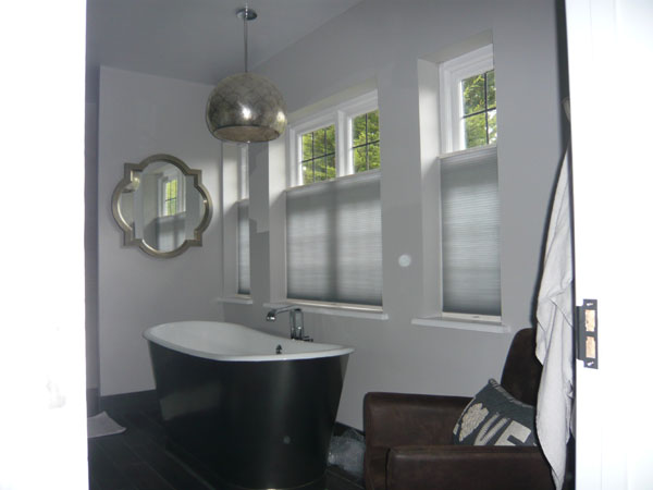 Grey bottom up Luxaflex Duette blinds for privacy in this North London bathroom