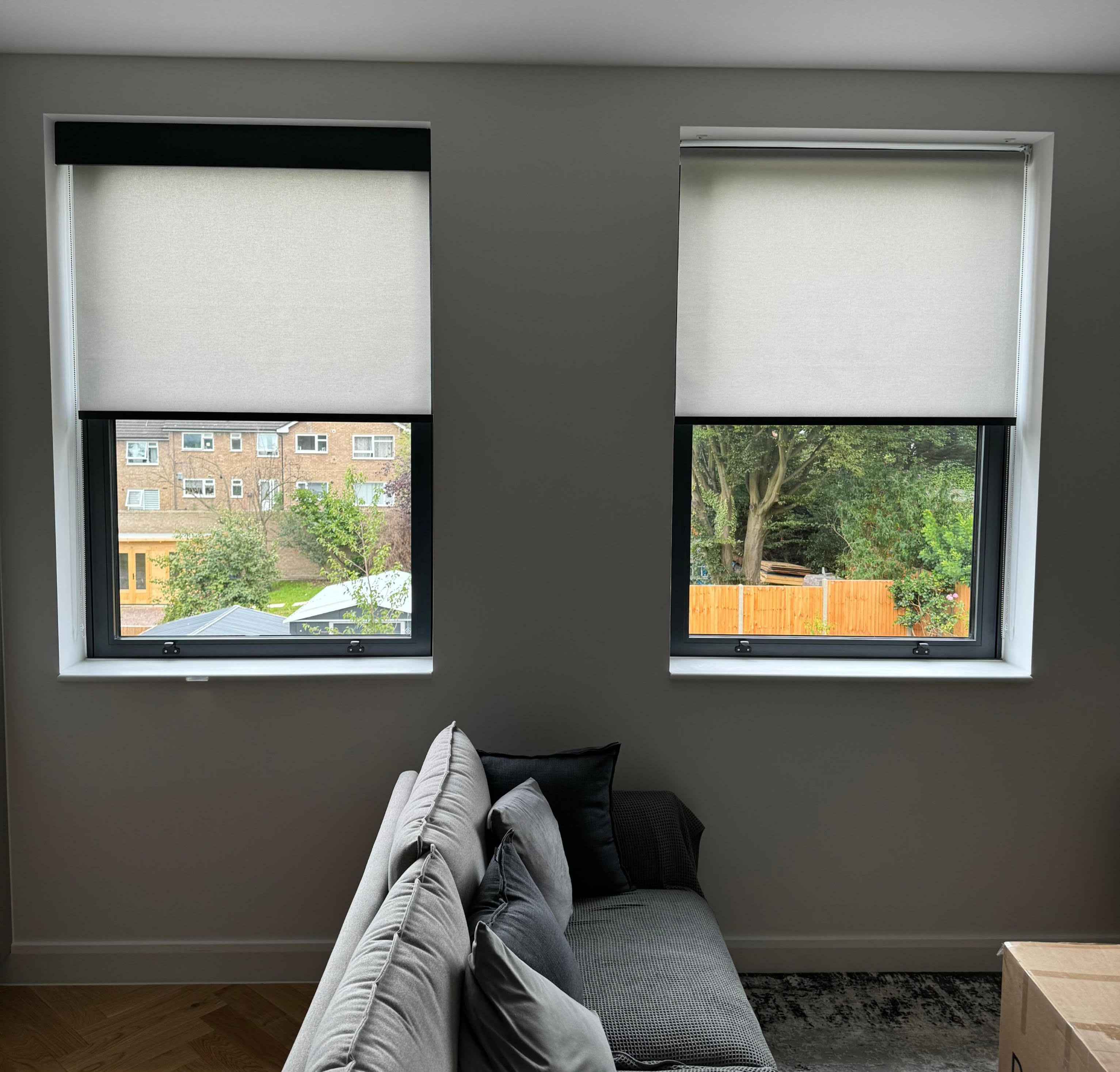 Two Electric Roller Blinds, partway through installation in North London, one of which has its Decorquip Fascia and one of which does not. Side by side for comparison.