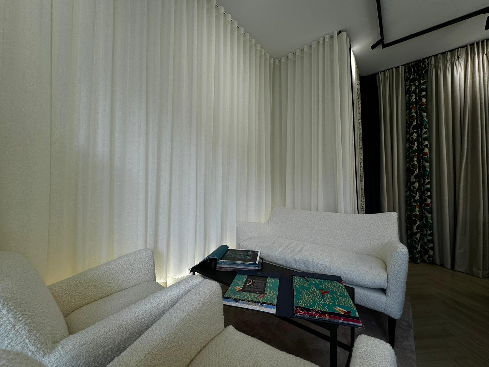 Designer furniture (which we also now sell) in our consulting area where clients and Interior Designers might peruse the latest fabrics in North London's finest Designer Fabric showroom, also displaying an uplit sheer wave curtain to disguise an otherwise plain wall